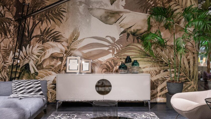 Elegant and cozy living room interior with tropical wallpaper, modern furniture, and vibrant decor accents.